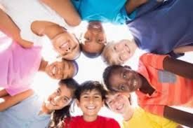 Children and Young people couselling Group of smiling children standing in a circle, looking down towards the camera.