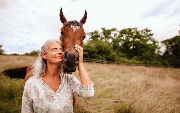 Two women engaged in conversation, one gesturing expressively.