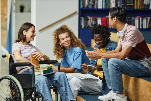 A diverse group of four friends engaging in conversation in a cozy library setting.